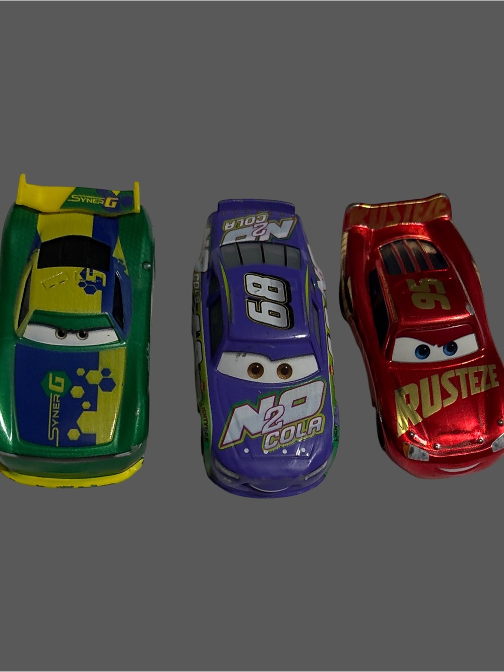 three collectible die-cast vehicles from the Disney Pixar Cars